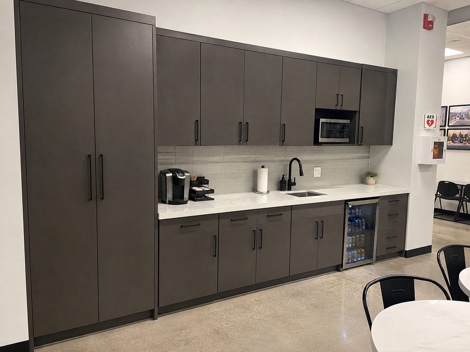 Commercial break room cabinetry with full-height storage and a laminate counter